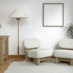 A calm and welcoming therapy waiting room with two white chairs, warm natural light, and soft natural tone